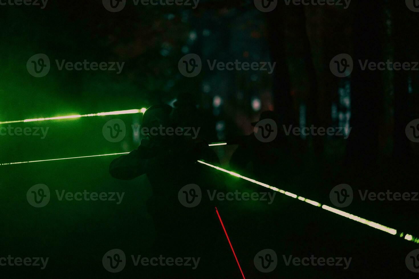 Soldiers squad in action on night mission using laser sight beam lights military team concept photo