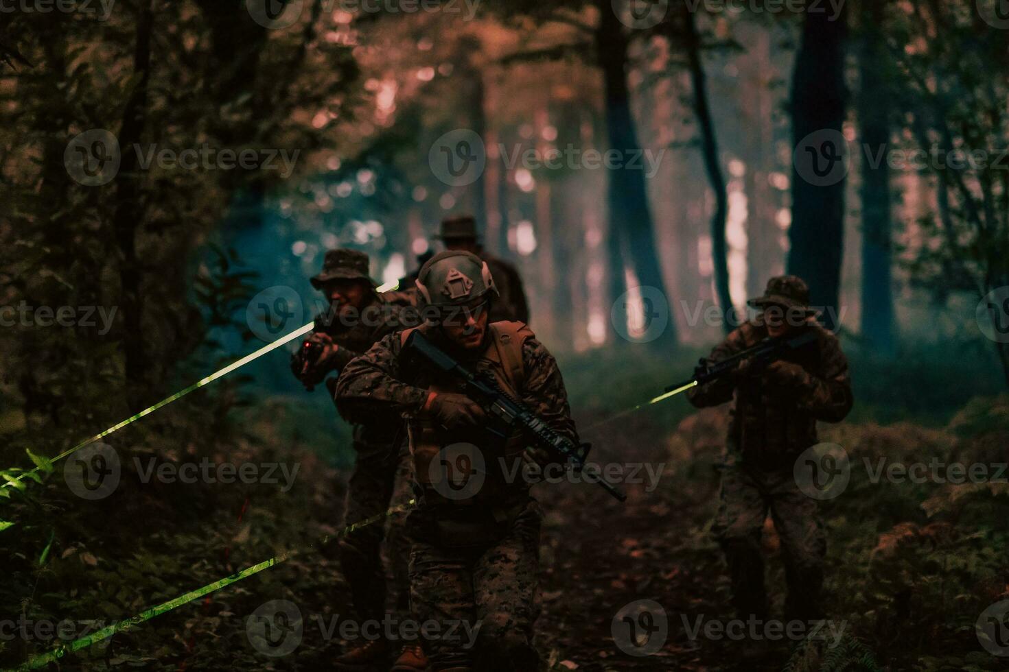 Soldiers squad in action on night mission using laser sight beam lights military team concept photo