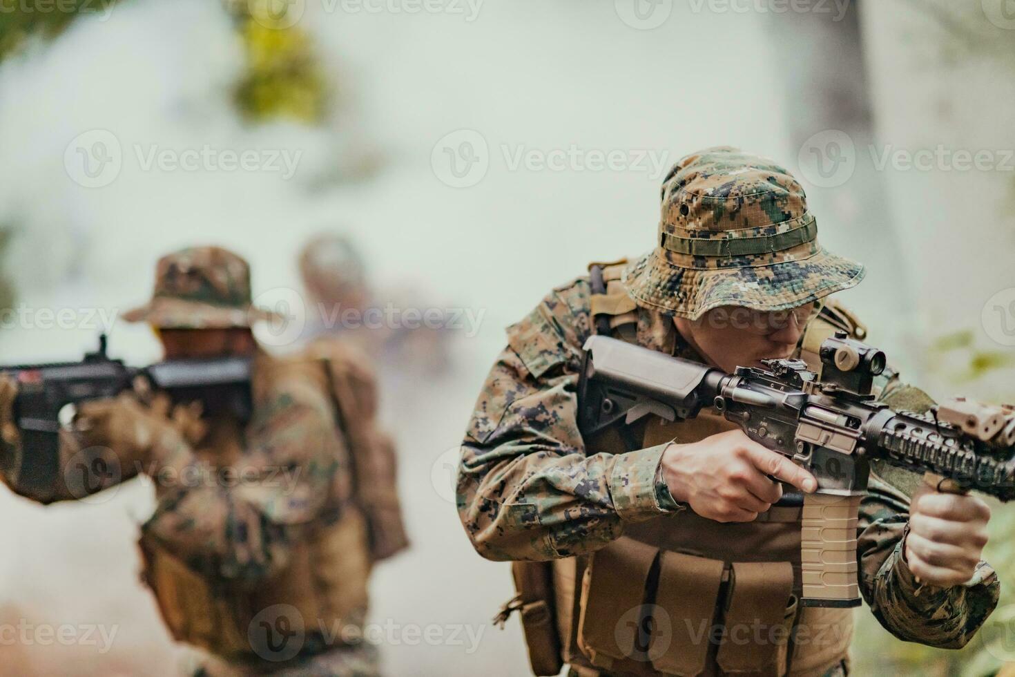 A group of modern warfare soldiers is fighting a war in dangerous remote forest areas. A group of soldiers is fighting on the enemy line with modern weapons. The concept of warfare and military conflicts photo