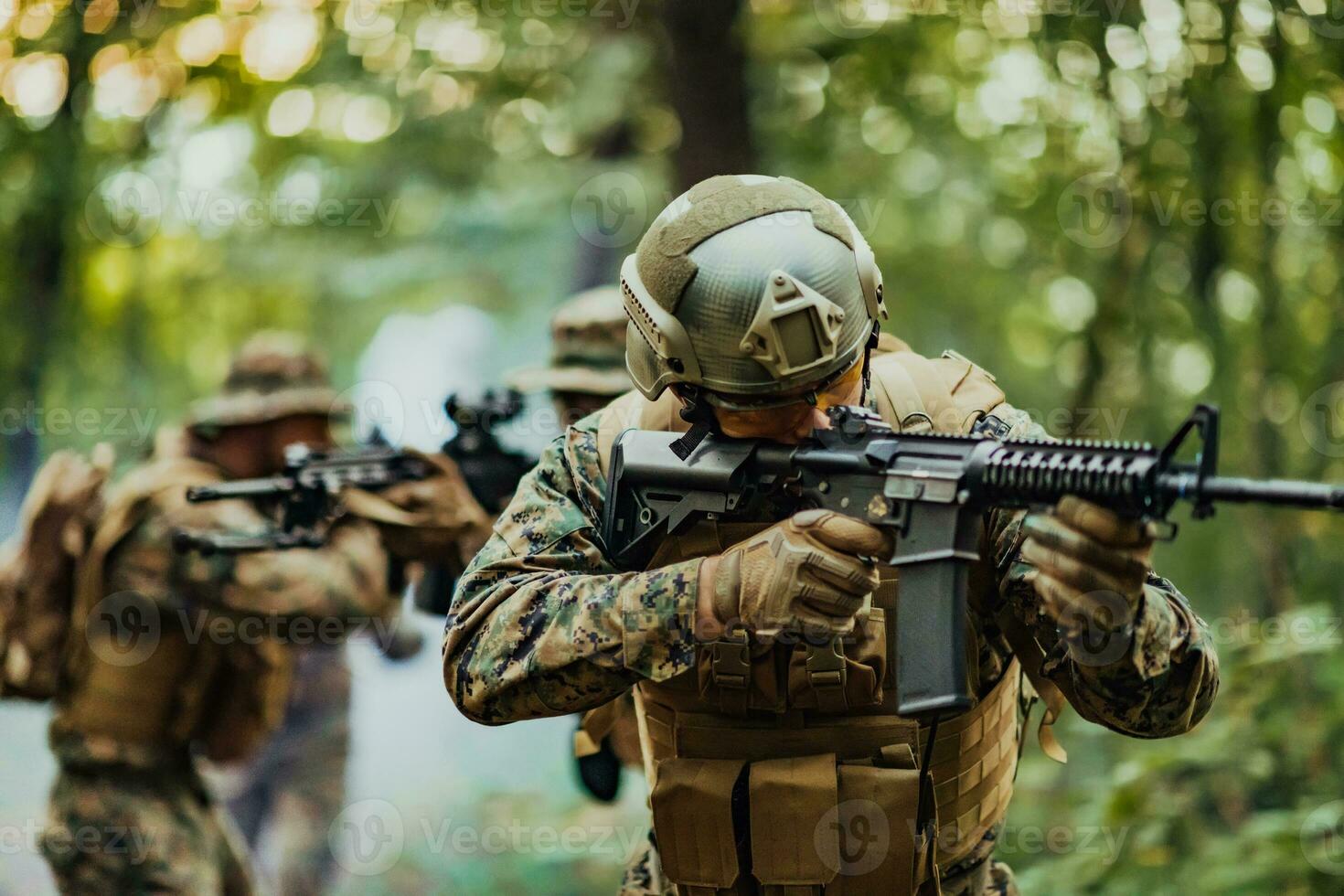 A group of modern warfare soldiers is fighting a war in dangerous remote forest areas. A group of soldiers is fighting on the enemy line with modern weapons. The concept of warfare and military conflicts photo