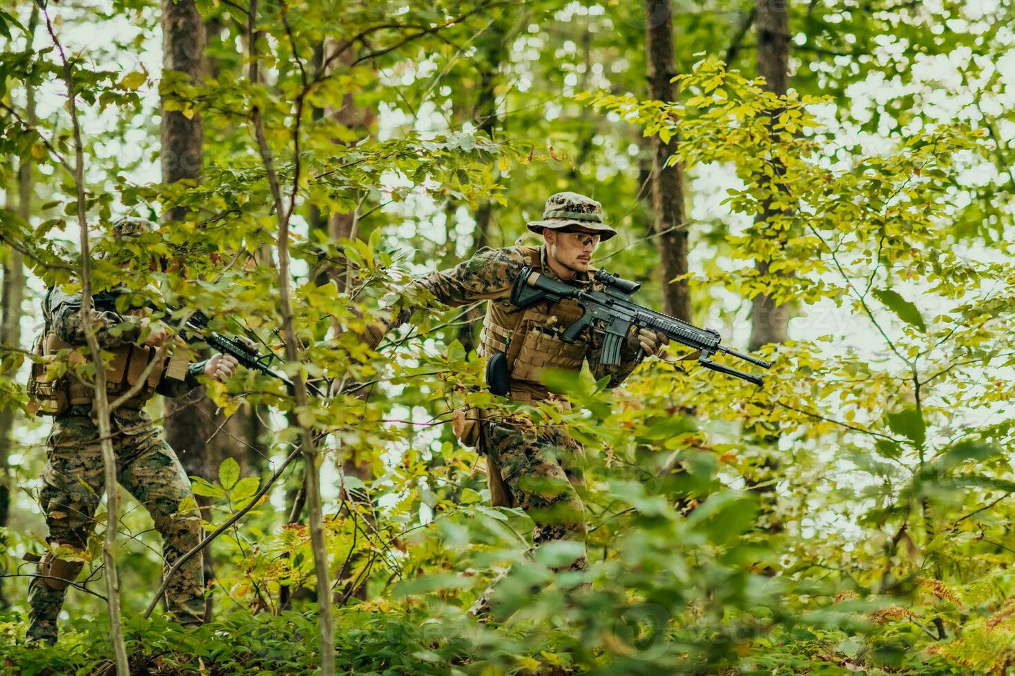 A modern warfare soldier on war duty in dense and dangerous forest areas. Dangerous military rescue operations photo