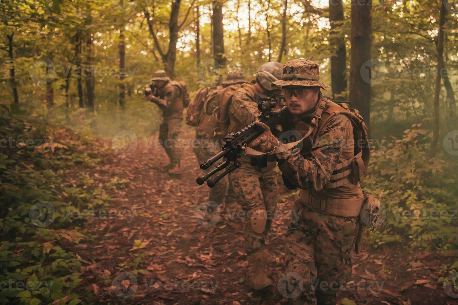 A group of modern warfare soldiers is fighting a war in dangerous remote forest areas. A group of soldiers is fighting on the enemy line with modern weapons. The concept of warfare and military conflicts photo