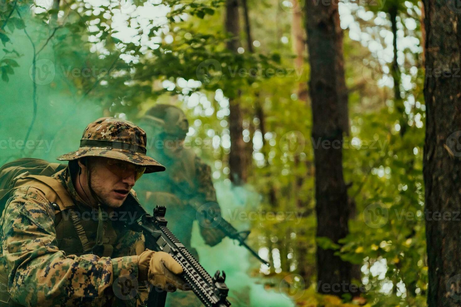 A group of modern warfare soldiers is fighting a war in dangerous remote forest areas. A group of soldiers is fighting on the enemy line with modern weapons. The concept of warfare and military conflicts photo