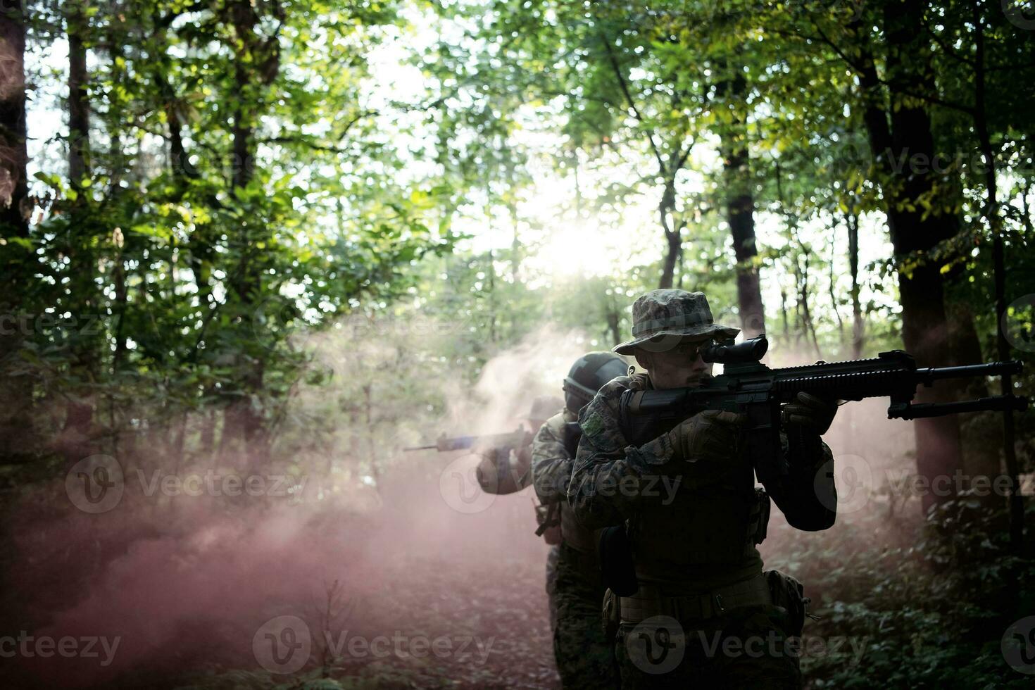 A group of modern warfare soldiers is fighting a war in dangerous remote forest areas. A group of soldiers is fighting on the enemy line with modern weapons. The concept of warfare and military conflicts photo