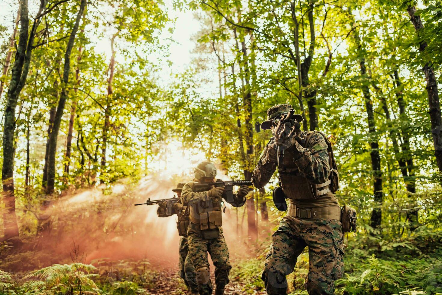 A group of modern warfare soldiers is fighting a war in dangerous remote forest areas. A group of soldiers is fighting on the enemy line with modern weapons. The concept of warfare and military conflicts photo