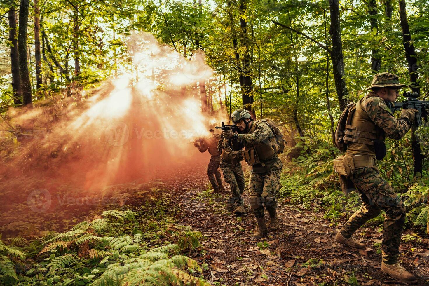 A group of modern warfare soldiers is fighting a war in dangerous remote forest areas. A group of soldiers is fighting on the enemy line with modern weapons. The concept of warfare and military conflicts photo