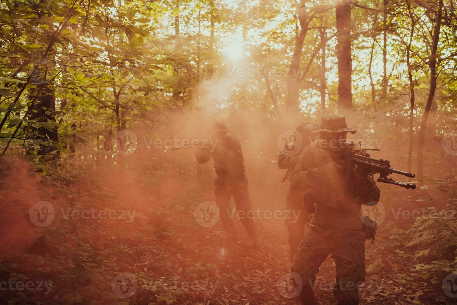 A group of modern warfare soldiers is fighting a war in dangerous remote forest areas. A group of soldiers is fighting on the enemy line with modern weapons. The concept of warfare and military conflicts photo
