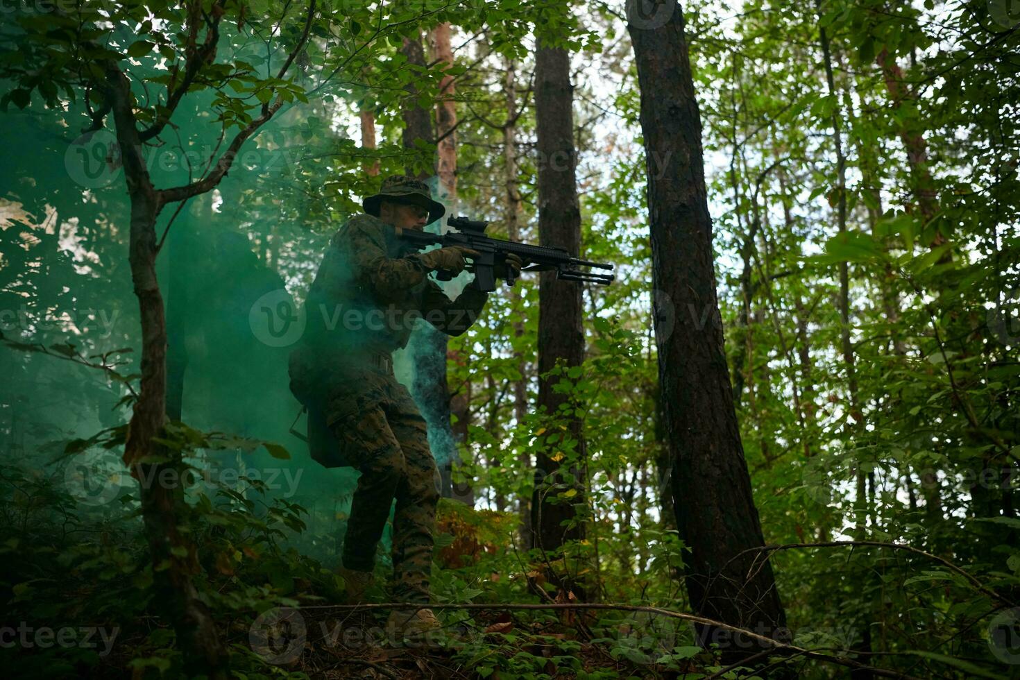 soldier in action aiming  on weapon  laser sight optics photo