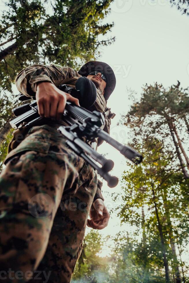 Soldier portrait with protective army tactical gear and weapon having a break and relaxing photo