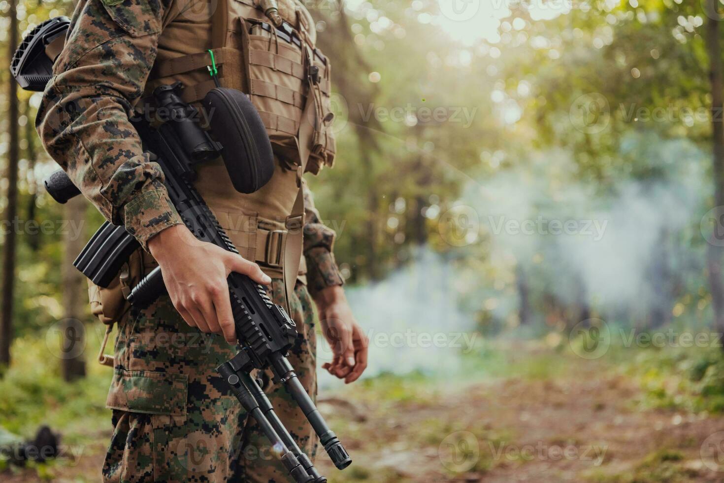 Soldier portrait with protective army tactical gear and weapon having a break and relaxing photo