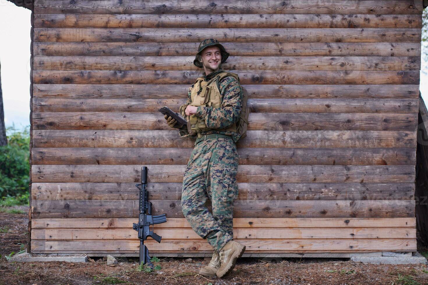 soldier using tablet computer in military camp photo