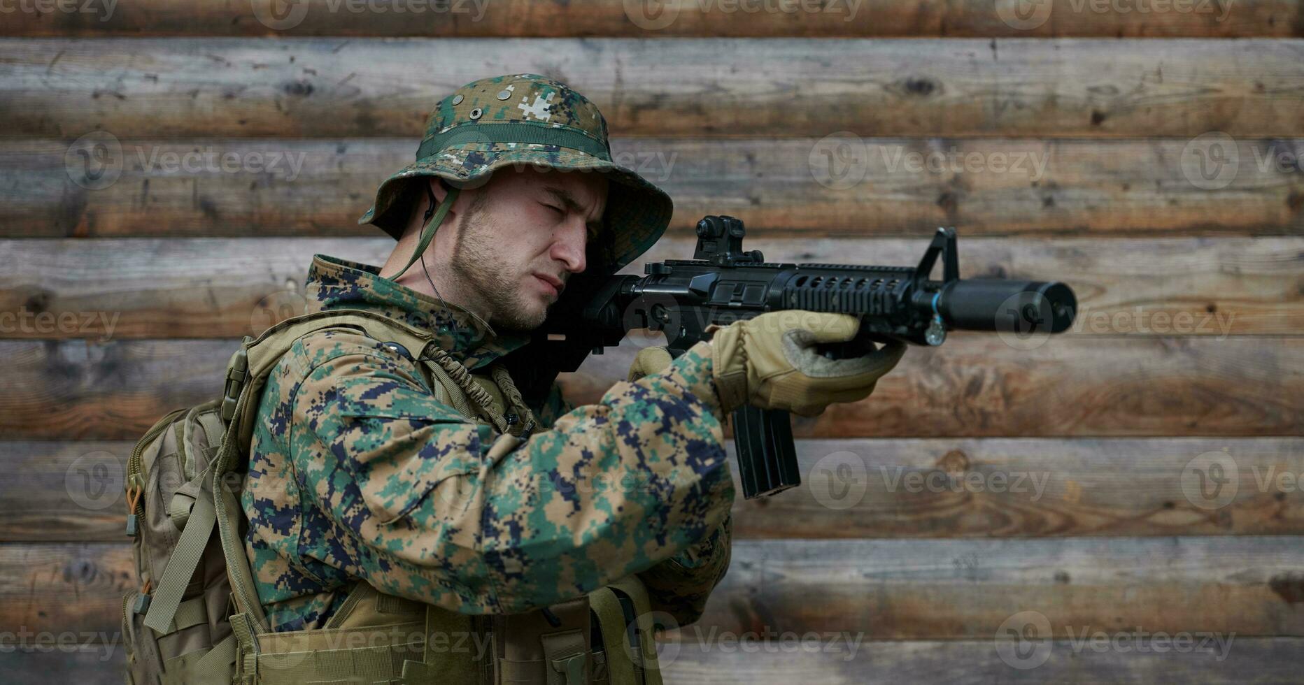 soldier in action aiming  on weapon  laser sight optics photo