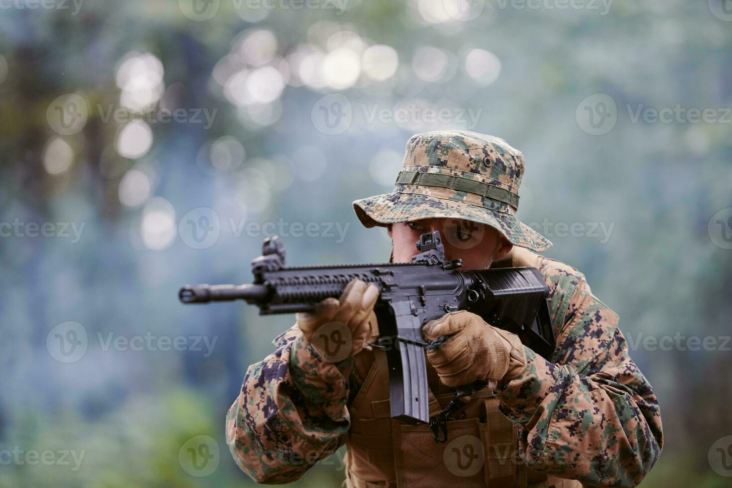 soldier in action aiming  on weapon  laser sight optics photo