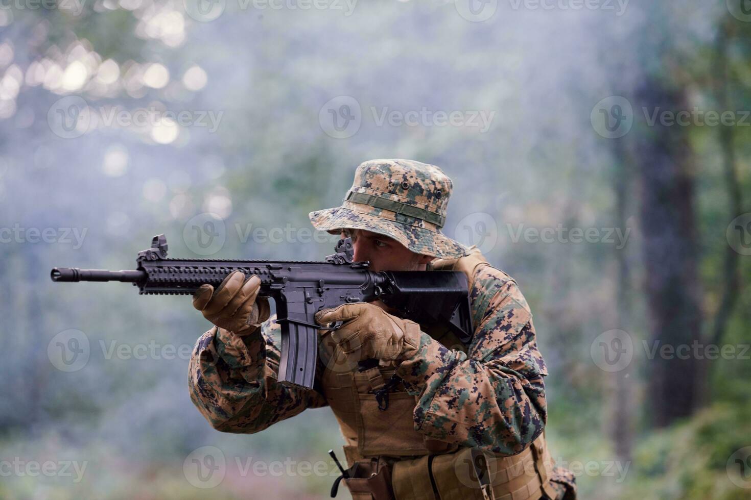 soldier in action aiming  on weapon  laser sight optics photo