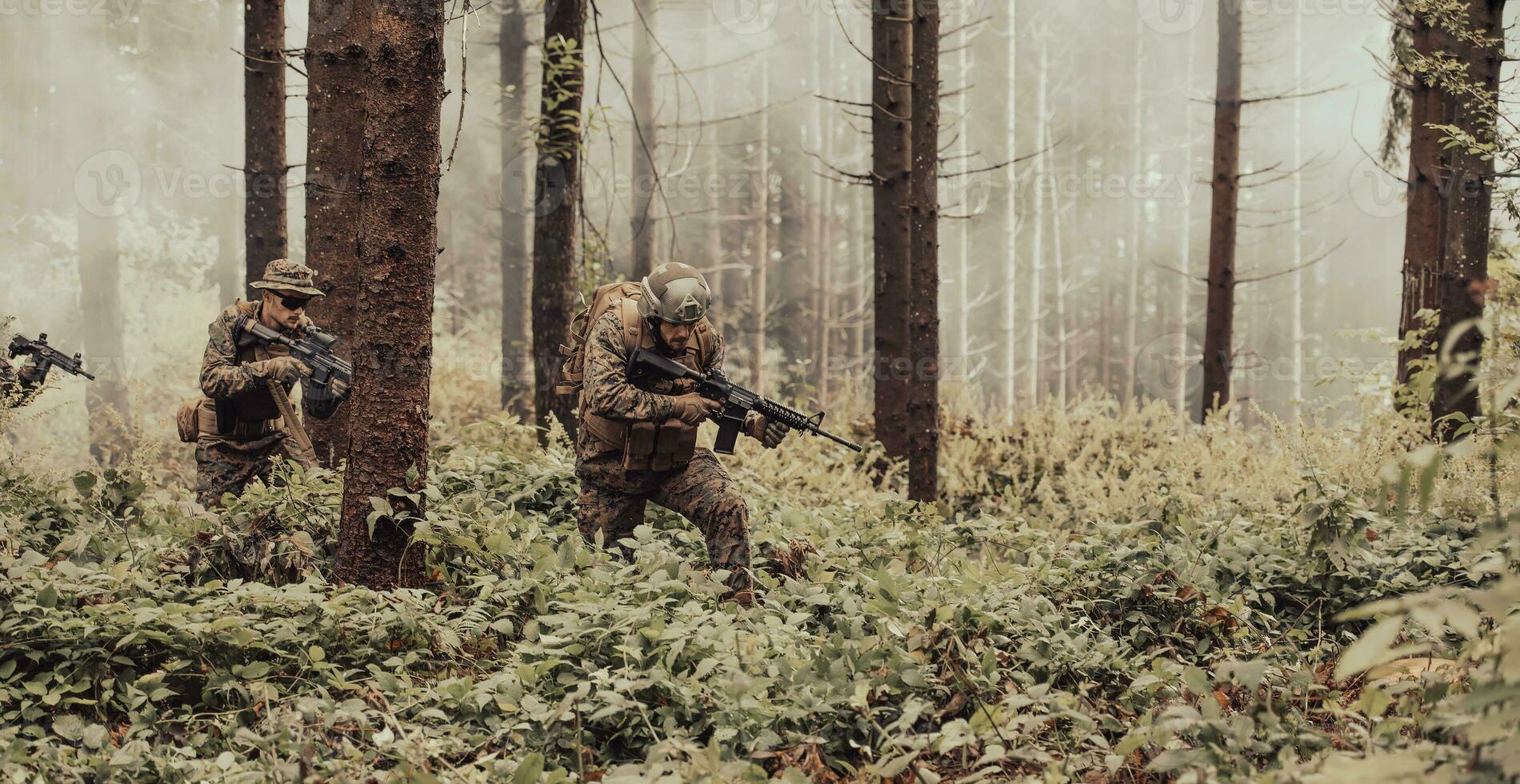 A group of modern warfare soldiers is fighting a war in dangerous remote forest areas. A group of soldiers is fighting on the enemy line with modern weapons. The concept of warfare and military conflicts photo