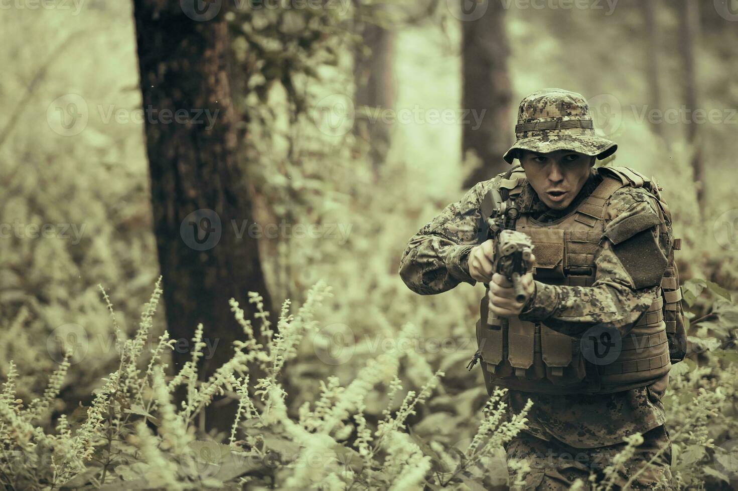 A modern warfare soldier on war duty in dense and dangerous forest areas. Dangerous military rescue operations photo