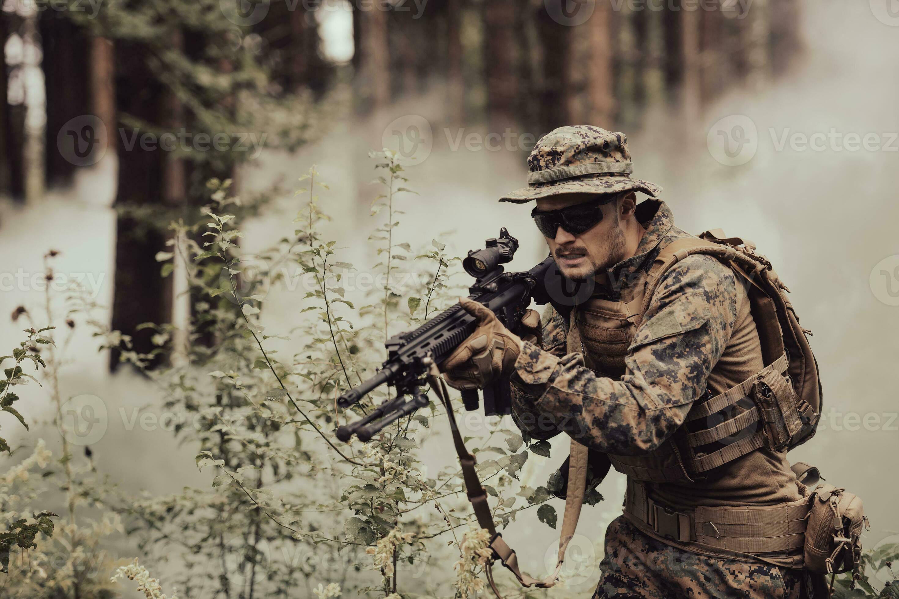 A modern warfare soldier on war duty in dense and dangerous forest ...