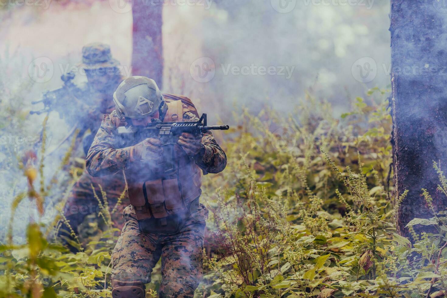 A group of modern warfare soldiers is fighting a war in dangerous remote forest areas. A group of soldiers is fighting on the enemy line with modern weapons. The concept of warfare and military conflicts photo