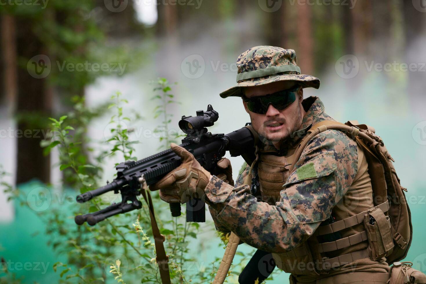 soldier in action aiming  on weapon  laser sight optics photo