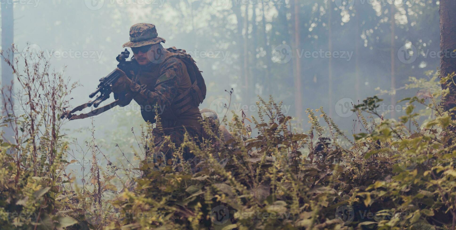 A modern warfare soldier on war duty in dense and dangerous forest areas. Dangerous military rescue operations photo