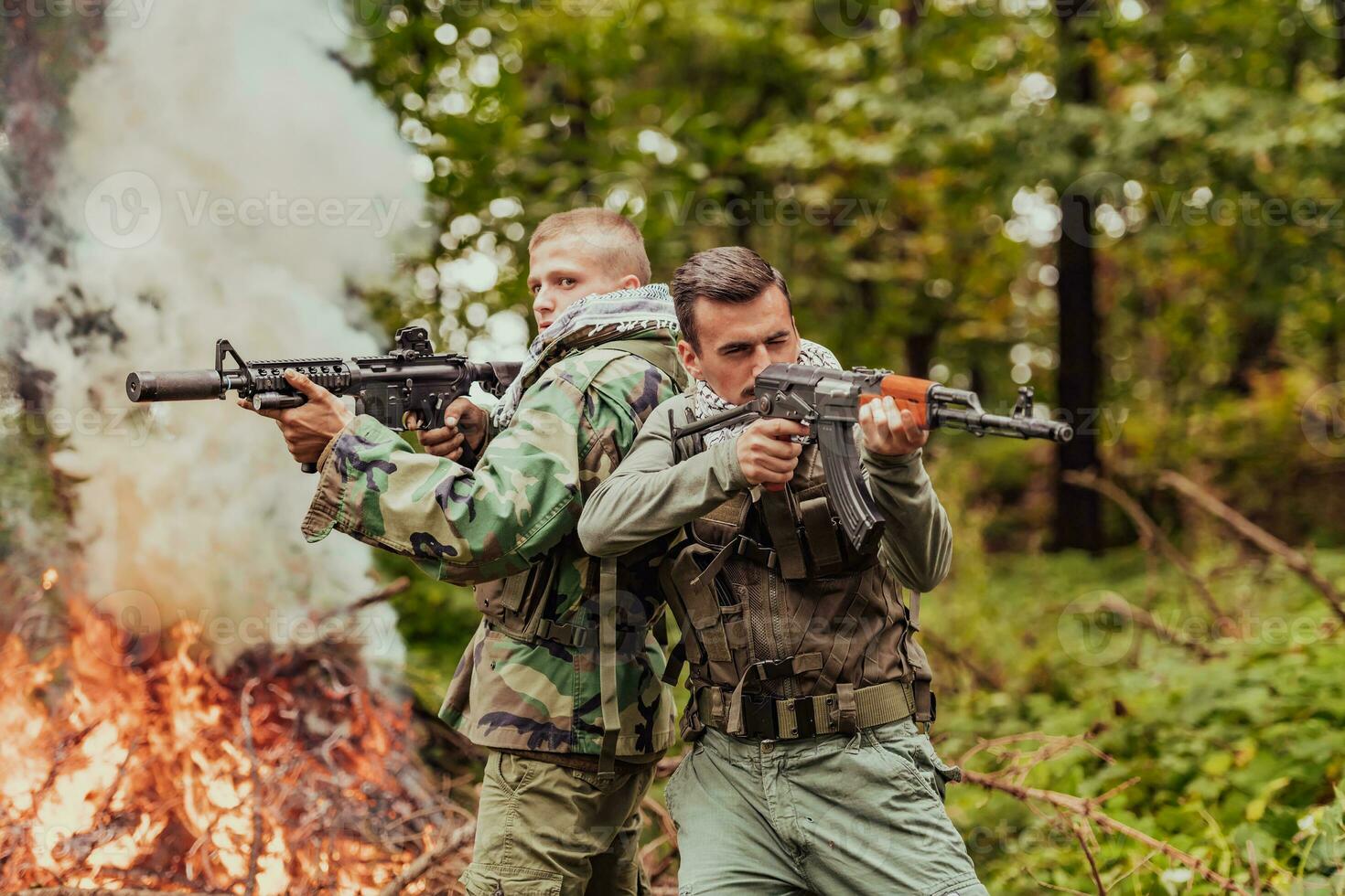 Angry terrorist militant guerrilla soldier warrior in forest photo