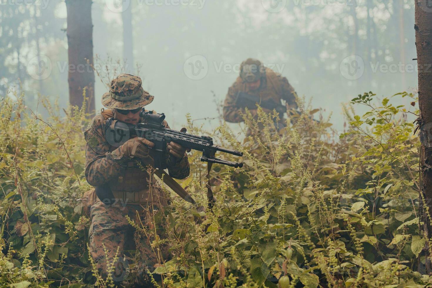 A group of modern warfare soldiers is fighting a war in dangerous remote forest areas. A group of soldiers is fighting on the enemy line with modern weapons. The concept of warfare and military conflicts photo