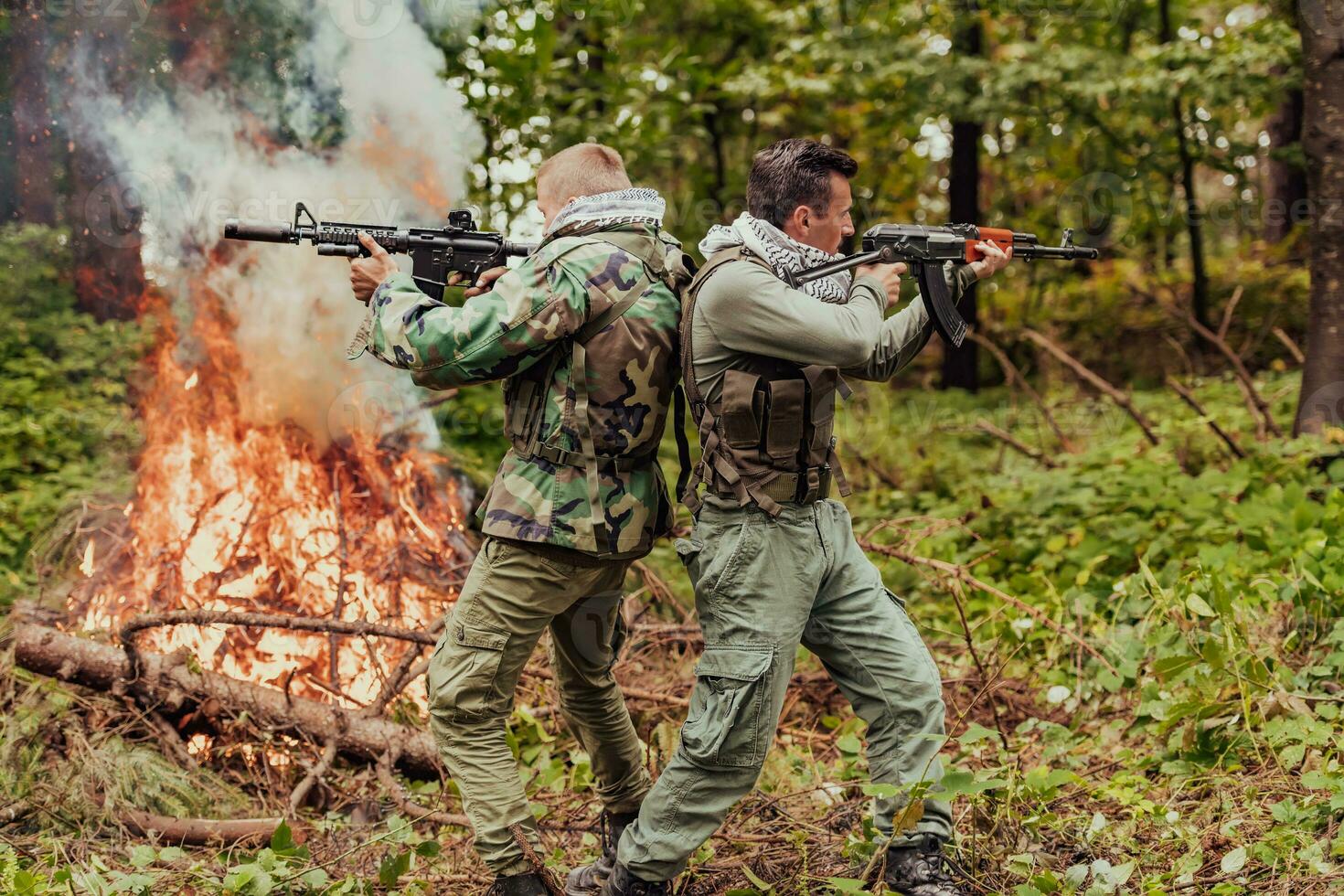 Angry terrorist militant guerrilla soldier warrior in forest photo