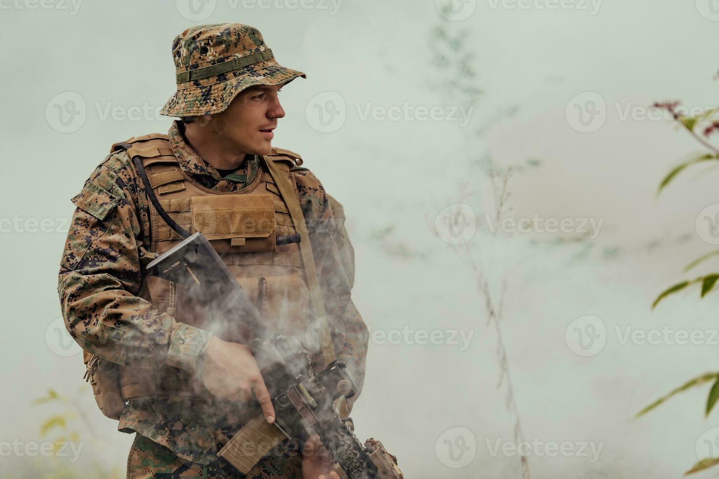 A soldier fights in a warforest area surrounded by fire photo