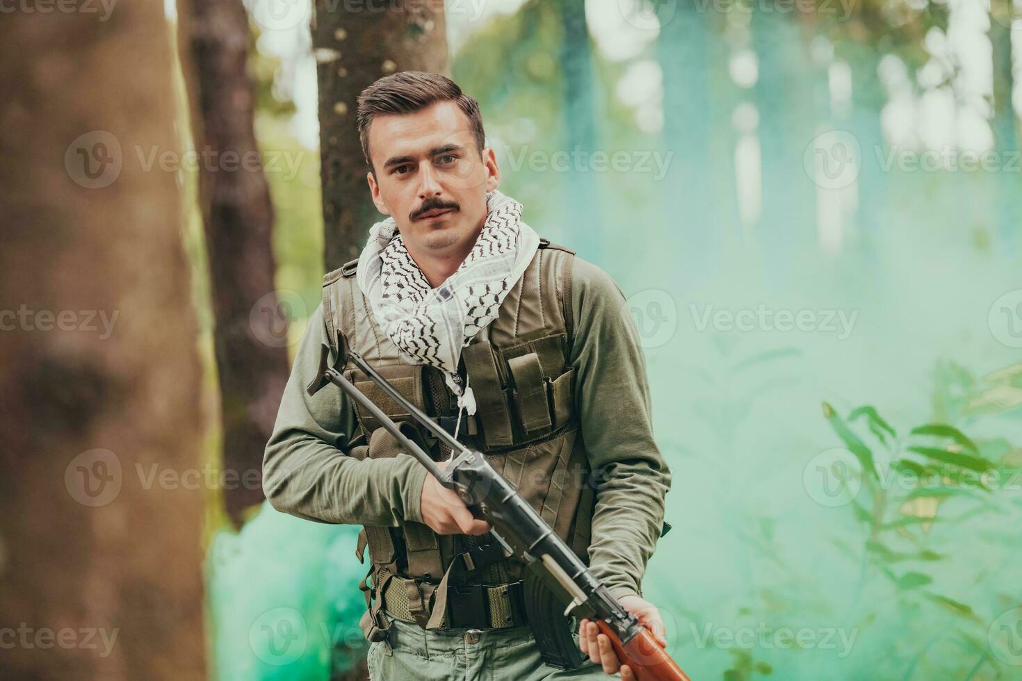 Angry terrorist militant guerrilla soldier warrior in forest photo