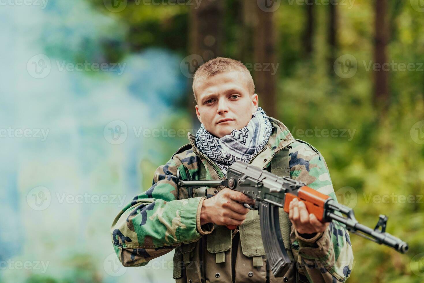 Angry terrorist militant guerrilla soldier warrior in forest photo