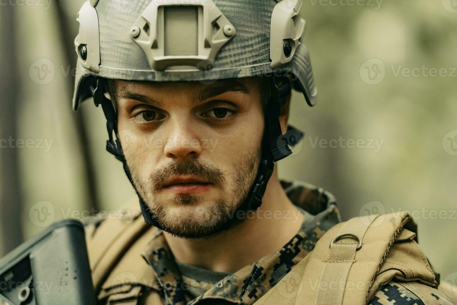 Soldier portrait with protective army tactical gear and weapon having a break and relaxing photo