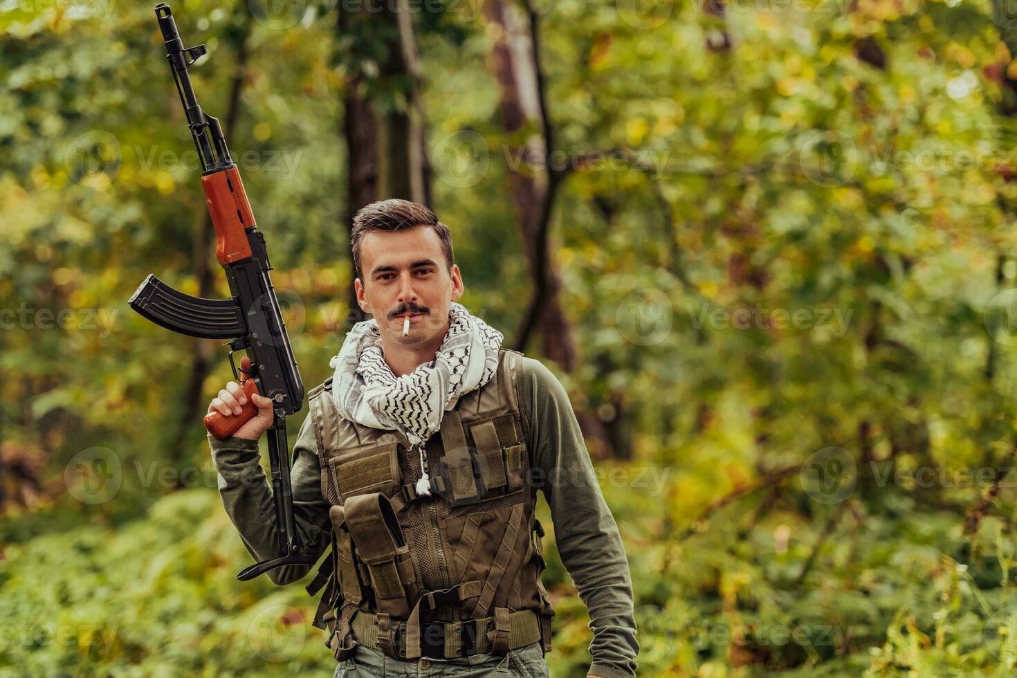 Terrorist have a break and smoke cigarette in forest during battle photo