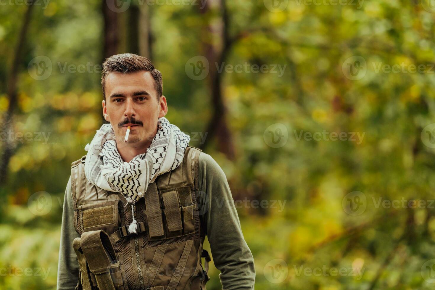 Terrorist have a break and smoke cigarette in forest during battle photo