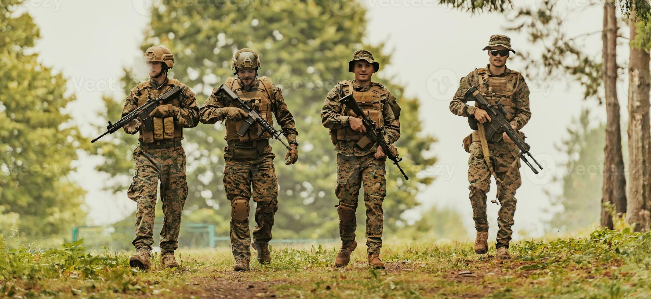 Soldier fighters standing together with guns. Group portrait of US army elite members, private military company servicemen, anti terrorist squad photo