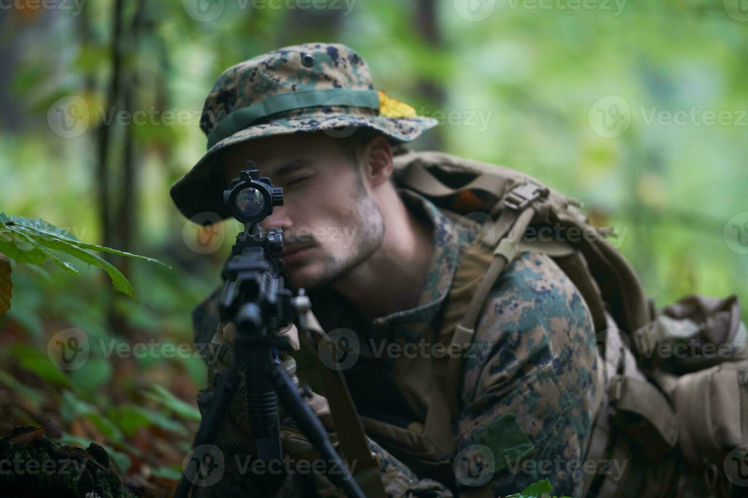 soldier in action aiming  on weapon  laser sight optics photo