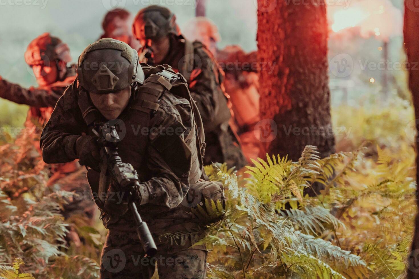 A group of modern warfare soldiers is fighting a war in dangerous remote forest areas. A group of soldiers is fighting on the enemy line with modern weapons. The concept of warfare and military conflicts photo