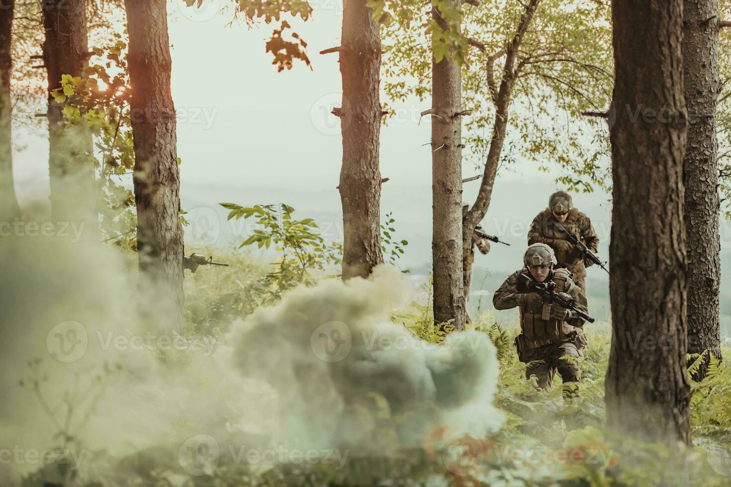 A group of modern warfare soldiers is fighting a war in dangerous remote forest areas. A group of soldiers is fighting on the enemy line with modern weapons. The concept of warfare and military conflicts photo