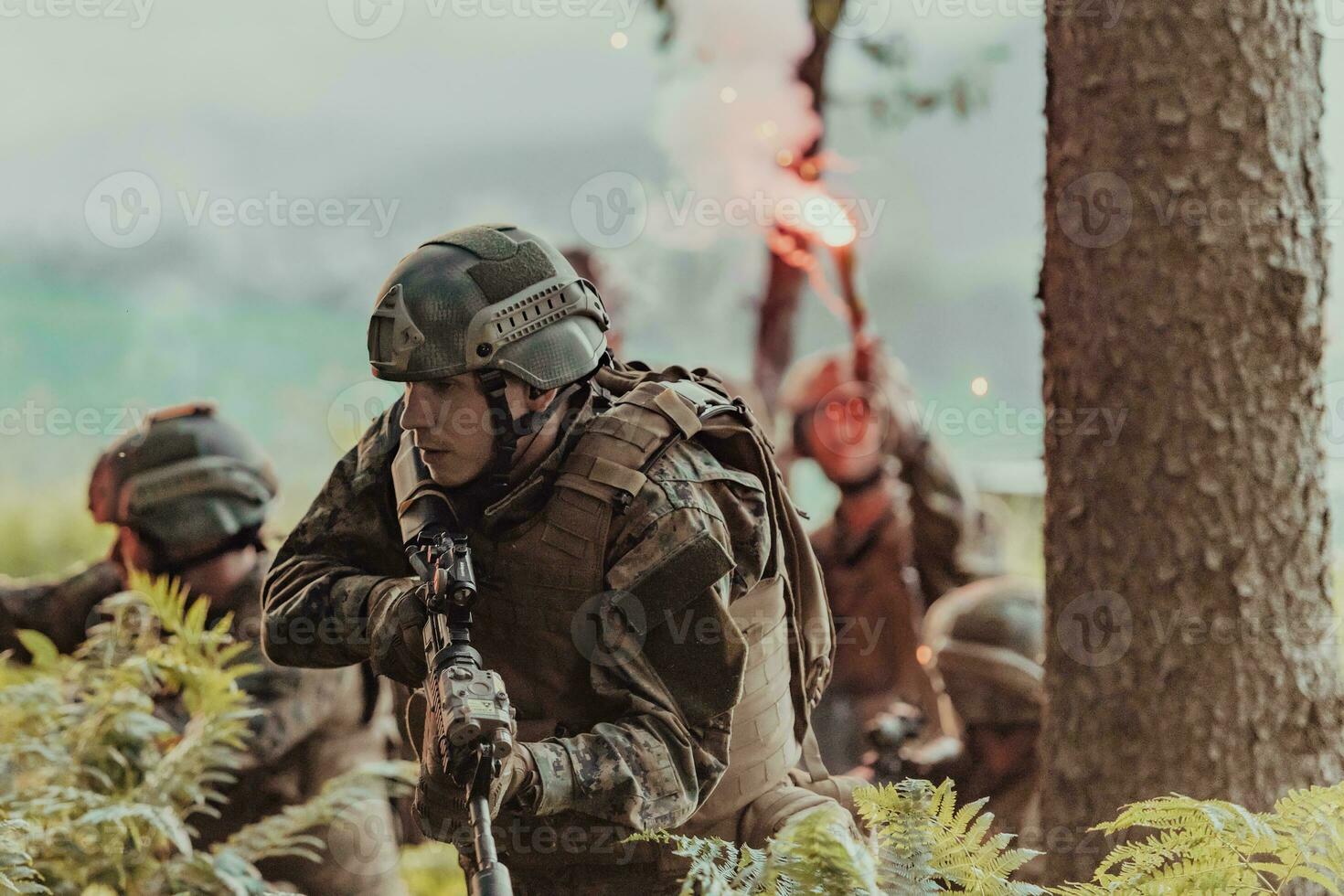 A group of modern warfare soldiers is fighting a war in dangerous remote forest areas. A group of soldiers is fighting on the enemy line with modern weapons. The concept of warfare and military conflicts photo