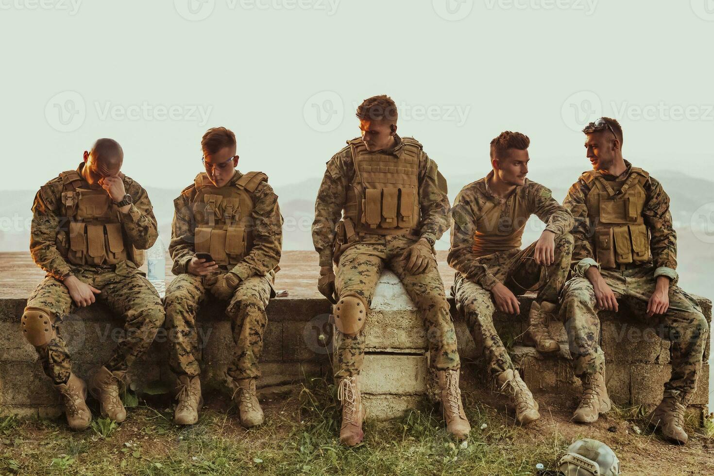 Soldiers squad relaxing after battle having a break on training photo