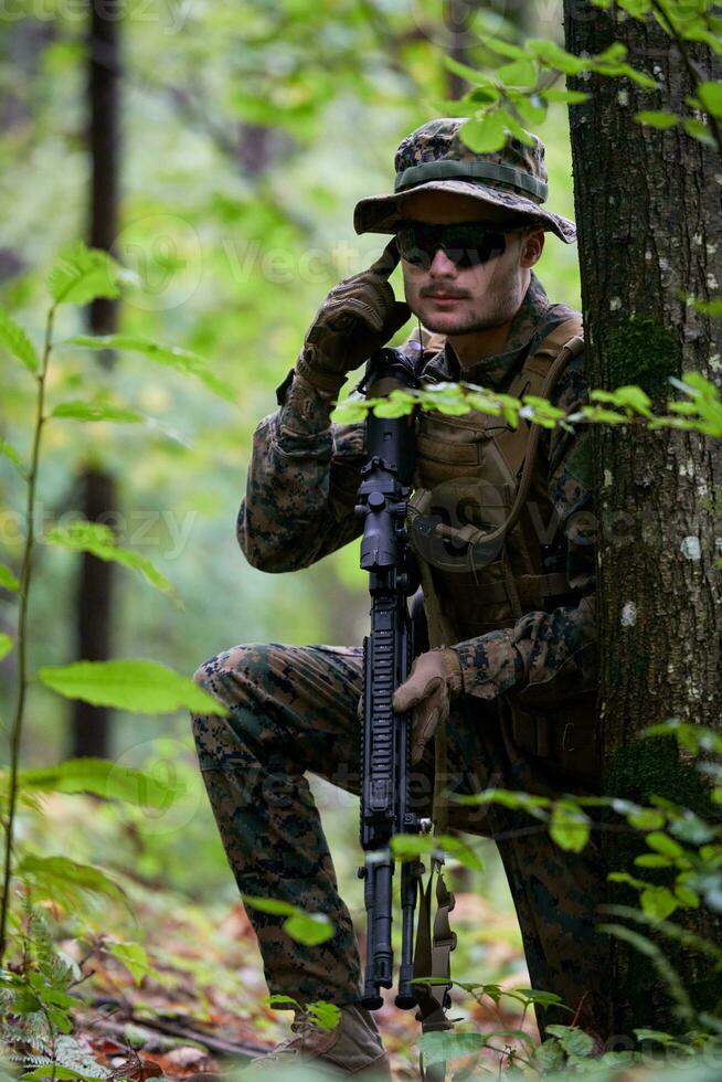 soldier preparing tactical and commpunication gear for action battle photo