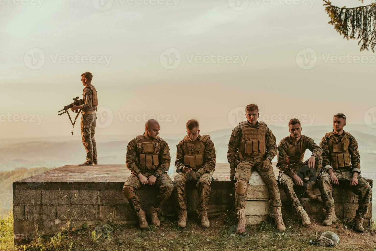 Soldiers squad relaxing after battle having a break on training photo