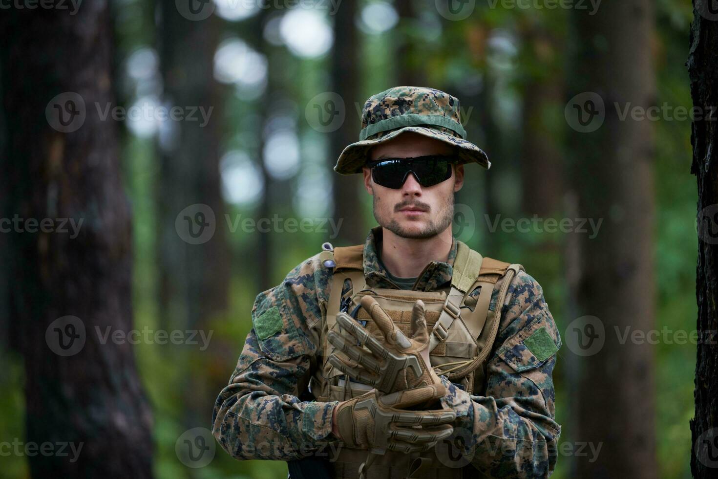 soldier preparing tactical and commpunication gear for action battle photo