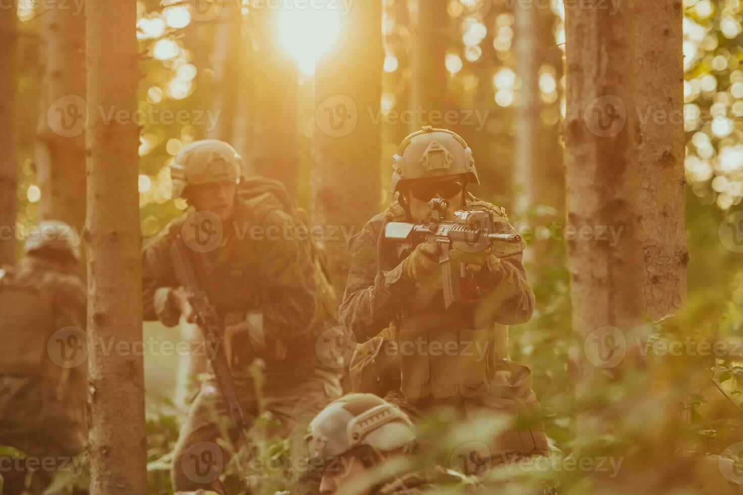 A group of modern warfare soldiers is fighting a war in dangerous remote forest areas. A group of soldiers is fighting on the enemy line with modern weapons. The concept of warfare and military conflicts photo