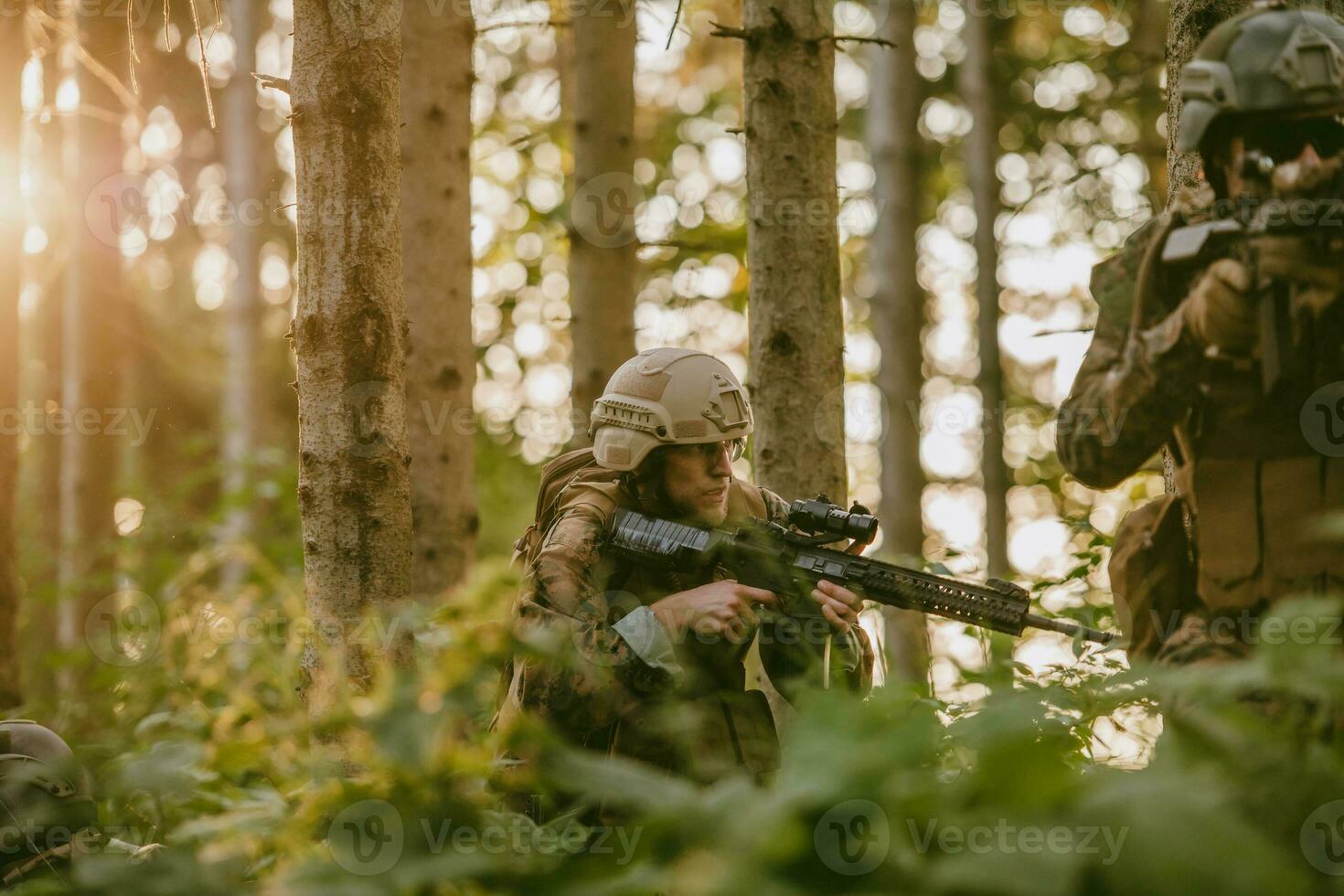 A group of modern warfare soldiers is fighting a war in dangerous remote forest areas. A group of soldiers is fighting on the enemy line with modern weapons. The concept of warfare and military conflicts photo