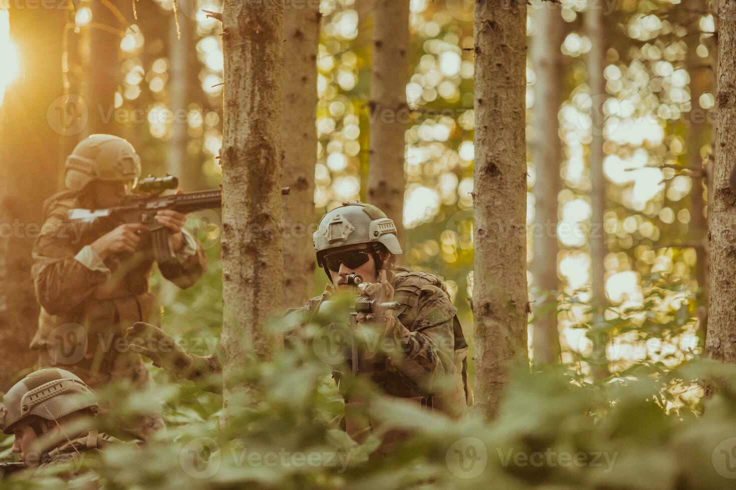 A group of modern warfare soldiers is fighting a war in dangerous remote forest areas. A group of soldiers is fighting on the enemy line with modern weapons. The concept of warfare and military conflicts photo