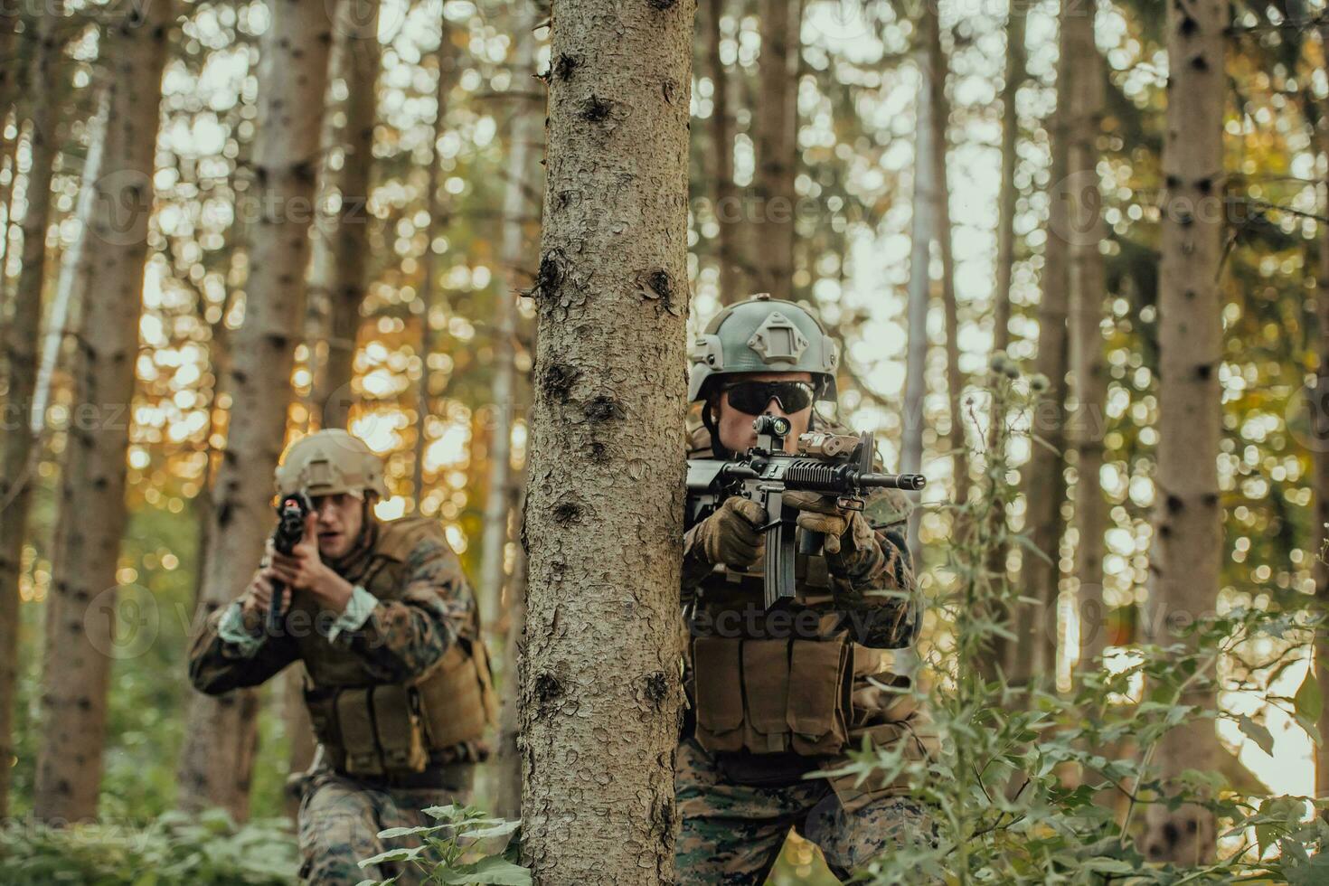 A group of modern warfare soldiers is fighting a war in dangerous remote forest areas. A group of soldiers is fighting on the enemy line with modern weapons. The concept of warfare and military conflicts photo