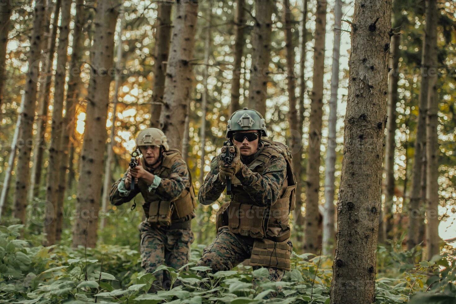 A group of modern warfare soldiers is fighting a war in dangerous remote forest areas. A group of soldiers is fighting on the enemy line with modern weapons. The concept of warfare and military conflicts photo