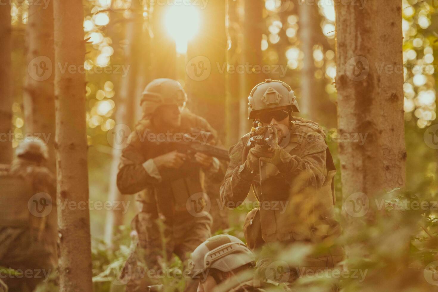 A group of modern warfare soldiers is fighting a war in dangerous remote forest areas. A group of soldiers is fighting on the enemy line with modern weapons. The concept of warfare and military conflicts photo