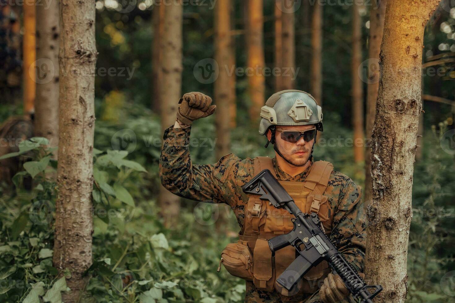 A group of modern warfare soldiers is fighting a war in dangerous remote forest areas. A group of soldiers is fighting on the enemy line with modern weapons. The concept of warfare and military conflicts photo