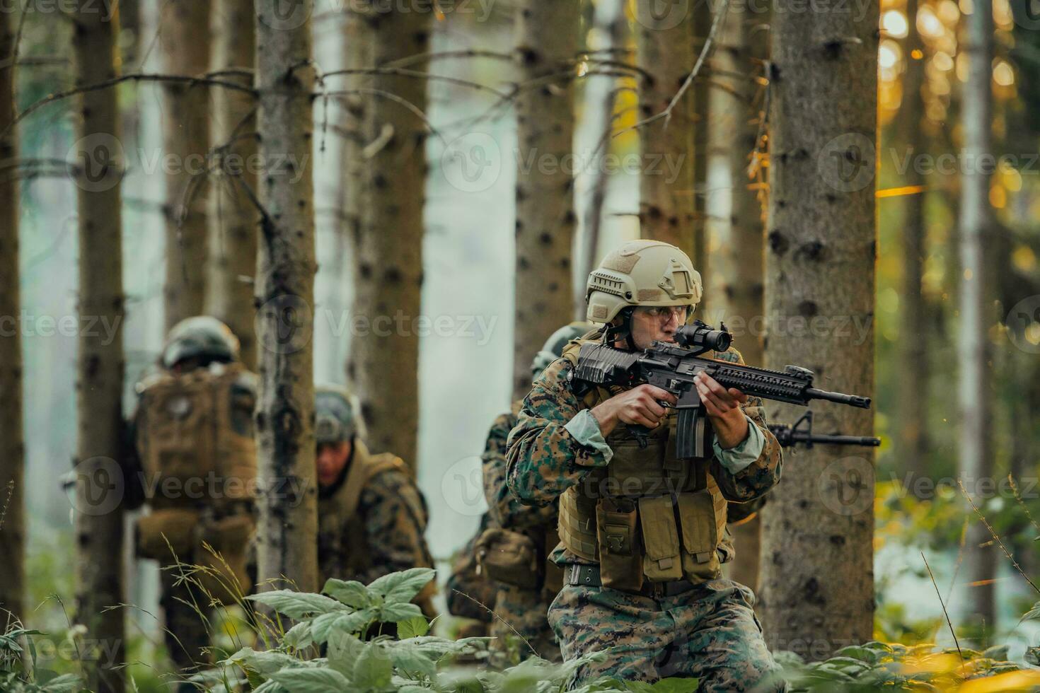 A group of modern warfare soldiers is fighting a war in dangerous remote forest areas. A group of soldiers is fighting on the enemy line with modern weapons. The concept of warfare and military conflicts photo